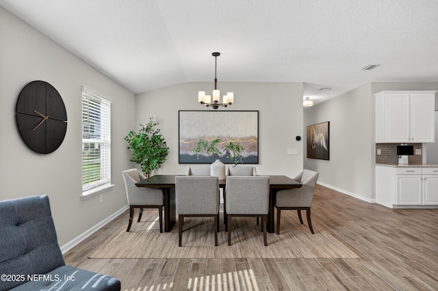 204 Bryson Dr, Fruit Cove, FL 32259 - dining space featuring a chandelier, light wood finished floors, and vaulted ceiling