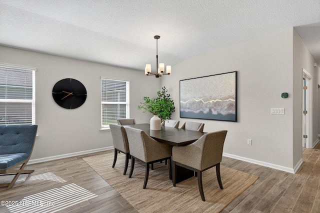 204 Bryson Dr, Fruit Cove, FL 32259 - dining space with a chandelier, light wood-style floors, and a textured ceiling