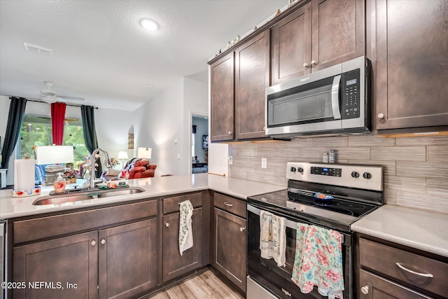 5 Bud Hollow Dr, Palm Coast, FL 32137 - kitchen with appliances with stainless steel finishes, light countertops, and dark brown cabinetry