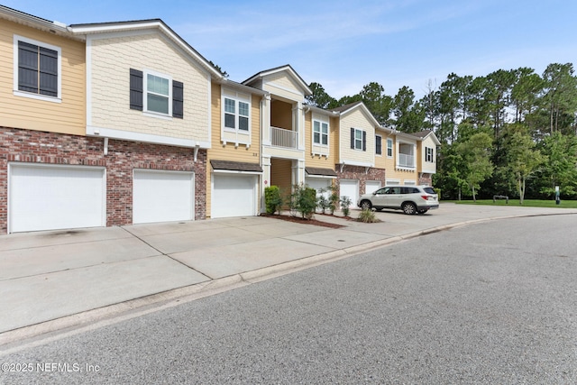 218 Larkin Pl Unit 110, Saint Johns, FL 32259 - multi unit property featuring concrete driveway, an attached garage, and brick siding