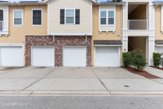 218 Larkin Pl Unit 110, Saint Johns, FL 32259 - view of property featuring a garage, driveway, and brick siding