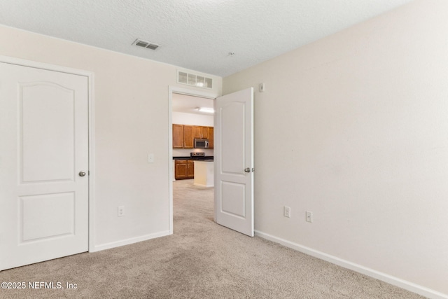 218 Larkin Pl Unit 110, Saint Johns, FL 32259 - unfurnished bedroom featuring light colored carpet and a textured ceiling