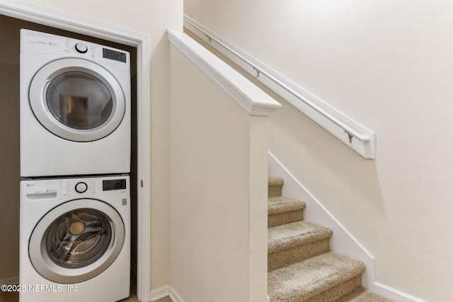 218 Larkin Pl Unit 110, Saint Johns, FL 32259 - washroom with stacked washer / dryer and baseboards