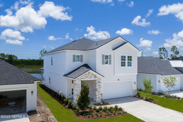 73 Ripple Rd, Saint Johns, FL 32095 - view of front of house with concrete driveway, stone siding, an attached garage, and roof with shingles
