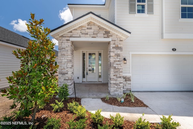 73 Ripple Rd, Saint Johns, FL 32095 - entrance to property with stone siding, concrete driveway, and a garage