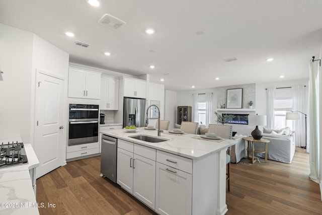 73 Ripple Rd, Saint Johns, FL 32095 - kitchen featuring stainless steel appliances, dark wood-style floors, white cabinetry, plenty of natural light, and recessed lighting