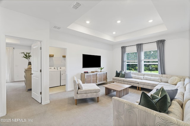 73 Ripple Rd, Saint Johns, FL 32095 - living area with washing machine and clothes dryer, light colored carpet, recessed lighting, and a tray ceiling