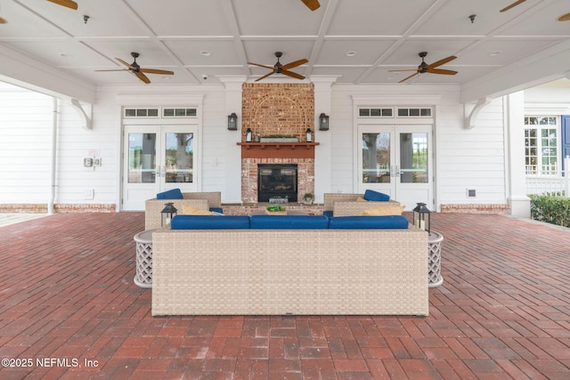 73 Ripple Rd, Saint Johns, FL 32095 - living area featuring french doors, ceiling fan, a brick fireplace, brick flooring, and coffered ceiling