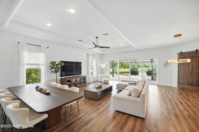 959 Crosswater Lake Dr, Ponte Vedra, FL 32081 - living room featuring a raised ceiling, wood finished floors, ceiling fan, recessed lighting, and a textured ceiling