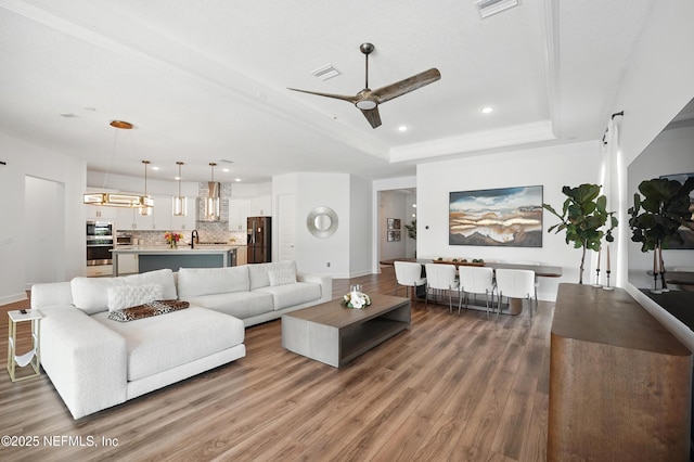 959 Crosswater Lake Dr, Ponte Vedra, FL 32081 - living area with a tray ceiling, wood finished floors, recessed lighting, and a ceiling fan