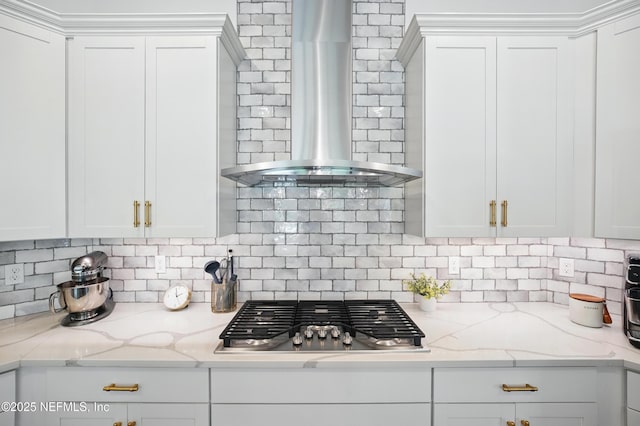 959 Crosswater Lake Dr, Ponte Vedra, FL 32081 - kitchen featuring wall chimney exhaust hood, stainless steel gas stovetop, white cabinets, and decorative backsplash
