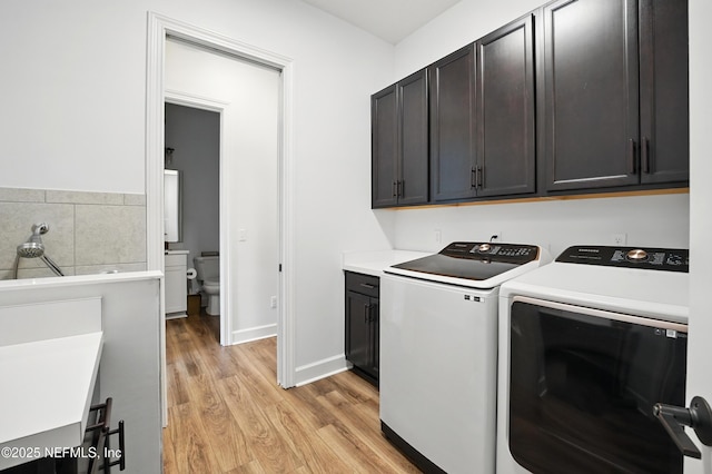 959 Crosswater Lake Dr, Ponte Vedra, FL 32081 - laundry area featuring cabinet space, light wood finished floors, and separate washer and dryer