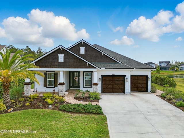 959 Crosswater Lake Dr, Ponte Vedra, FL 32081 - view of front of property featuring a garage, concrete driveway, a front yard, a shingled roof, and a porch