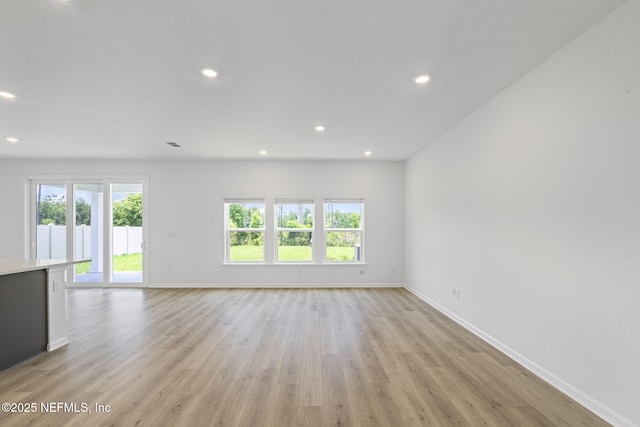 386 Whirlwind Pl, Saint Johns, FL 32095 - unfurnished living room featuring light wood finished floors and recessed lighting
