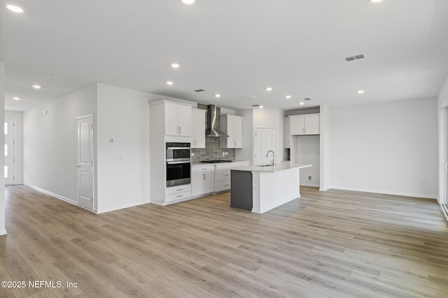386 Whirlwind Pl, Saint Johns, FL 32095 - kitchen with wall chimney range hood, open floor plan, gas stovetop, double oven, and recessed lighting