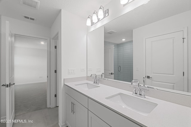 386 Whirlwind Pl, Saint Johns, FL 32095 - full bath with double vanity, a shower stall, tile patterned floors, and a textured ceiling