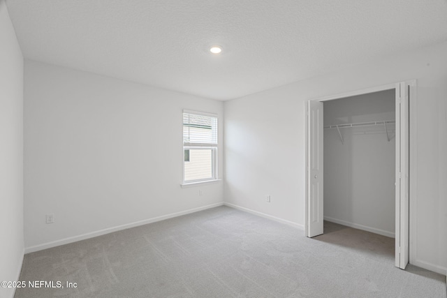 386 Whirlwind Pl, Saint Johns, FL 32095 - unfurnished bedroom featuring carpet floors, a closet, and a textured ceiling