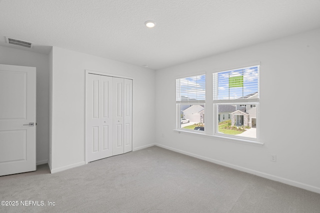 386 Whirlwind Pl, Saint Johns, FL 32095 - unfurnished bedroom featuring carpet floors, a closet, and a textured ceiling