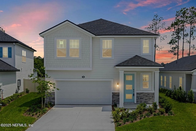 386 Whirlwind Pl, Saint Johns, FL 32095 - view of front of property with an attached garage, concrete driveway, stone siding, and a shingled roof