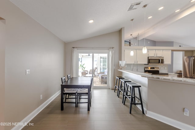 4521 Deep River Way E, Jacksonville, FL 32224 - dining space featuring vaulted ceiling and recessed lighting