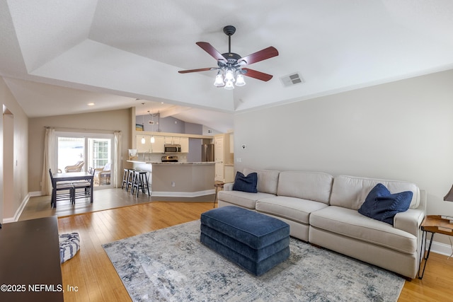 4521 Deep River Way E, Jacksonville, FL 32224 - living area featuring vaulted ceiling, ceiling fan, light wood finished floors, and recessed lighting