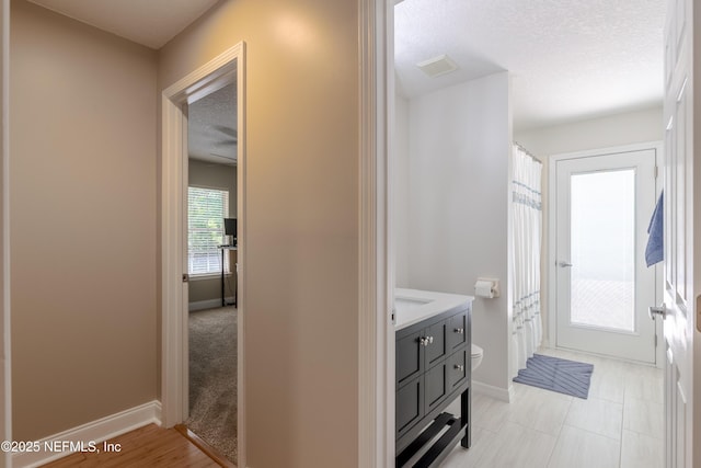 4521 Deep River Way E, Jacksonville, FL 32224 - corridor featuring a textured ceiling and baseboards