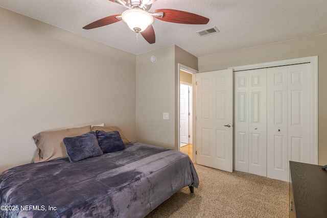 4521 Deep River Way E, Jacksonville, FL 32224 - bedroom with light carpet, a closet, ceiling fan, and a textured ceiling