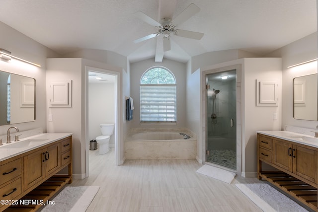 4521 Deep River Way E, Jacksonville, FL 32224 - full bath featuring a garden tub, a stall shower, two vanities, ceiling fan, and vaulted ceiling