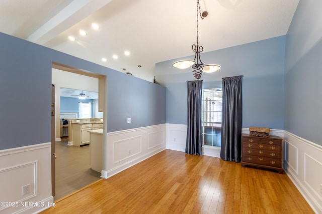 4521 Deep River Way E, Jacksonville, FL 32224 - spare room with wainscoting, light wood finished floors, a decorative wall, and lofted ceiling
