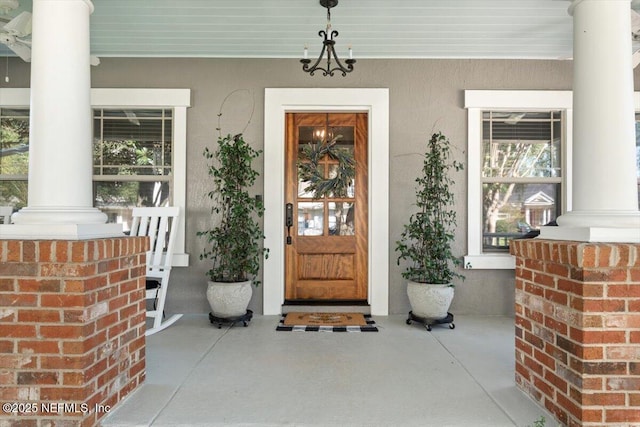 1060 Meadow View Ln, Saint Augustine, FL 32092 - doorway to property featuring covered porch and stucco siding