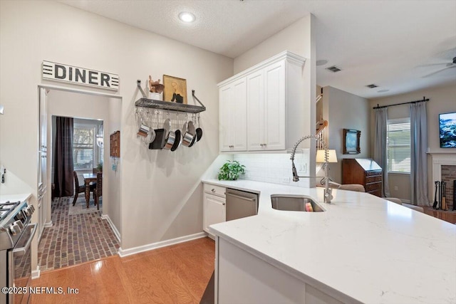 1060 Meadow View Ln, Saint Augustine, FL 32092 - kitchen with stainless steel appliances, white cabinets, plenty of natural light, tasteful backsplash, and recessed lighting