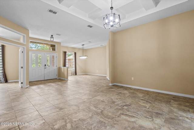 3728 W Florentine Dr, Citrus Springs, FL 34433 - foyer featuring a chandelier, coffered ceiling, light stone finish flooring, and beamed ceiling