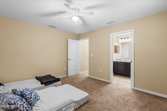 3728 W Florentine Dr, Citrus Springs, FL 34433 - bedroom featuring light colored carpet, ensuite bathroom, and ceiling fan