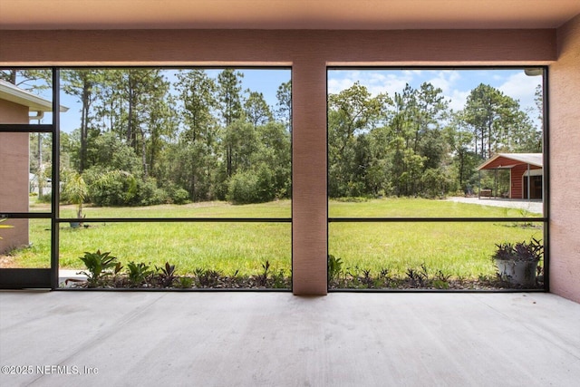 3728 W Florentine Dr, Citrus Springs, FL 34433 - unfurnished sunroom featuring view of wooded area
