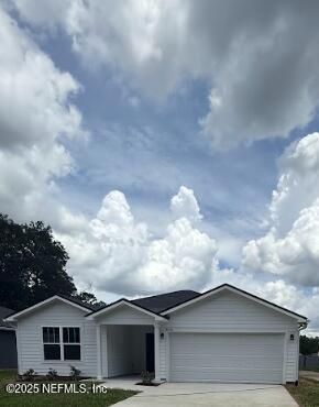 8045 Driggers St, Jacksonville, FL 32220 - ranch-style house with concrete driveway and a garage