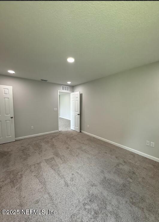 8045 Driggers St, Jacksonville, FL 32220 - carpeted empty room with recessed lighting and a textured ceiling