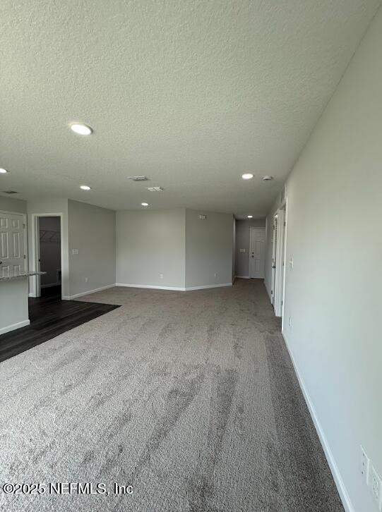8045 Driggers St, Jacksonville, FL 32220 - unfurnished room featuring recessed lighting, dark carpet, and a textured ceiling