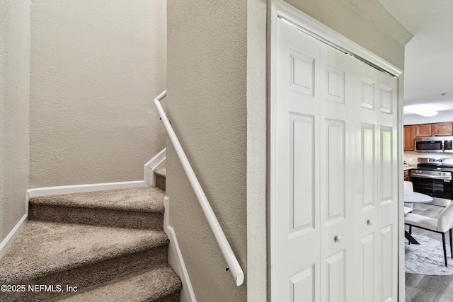 8550 Touchton Rd Unit 932, Jacksonville, FL 32216 - stairway with a textured wall and wood finished floors