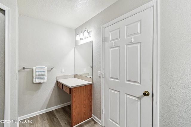 8550 Touchton Rd Unit 932, Jacksonville, FL 32216 - bathroom with wood finished floors, vanity, a textured ceiling, and a textured wall