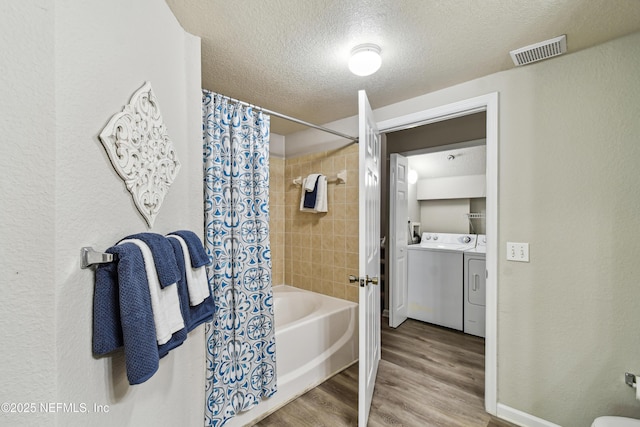 8550 Touchton Rd Unit 932, Jacksonville, FL 32216 - full bathroom with independent washer and dryer, shower / tub combo, a textured ceiling, wood finished floors, and vanity