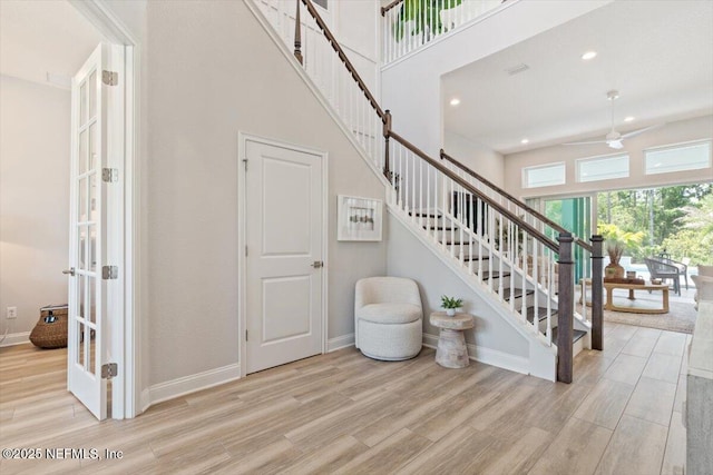 351 Palm Crst Dr, Ponte Vedra, FL 32081 - stairs featuring wood finished floors, a ceiling fan, a towering ceiling, and recessed lighting