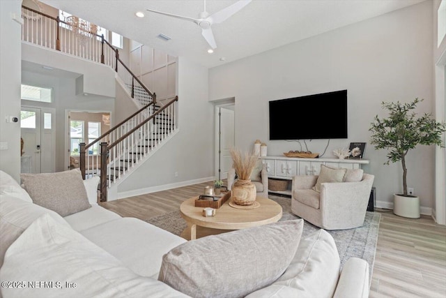 351 Palm Crst Dr, Ponte Vedra, FL 32081 - living room with a ceiling fan, light wood-type flooring, stairs, a high ceiling, and recessed lighting