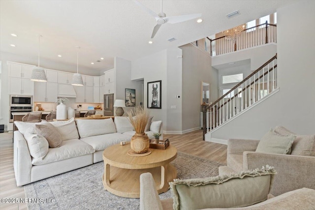351 Palm Crst Dr, Ponte Vedra, FL 32081 - living room with light wood-style flooring, a towering ceiling, stairway, ceiling fan, and recessed lighting