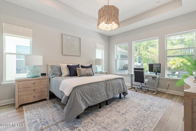 351 Palm Crst Dr, Ponte Vedra, FL 32081 - bedroom with a chandelier, a desk, light wood-style floors, and a raised ceiling