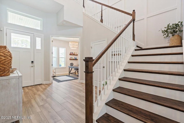 351 Palm Crst Dr, Ponte Vedra, FL 32081 - foyer with stairway, a chandelier, light wood-style floors, and a high ceiling