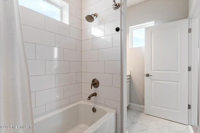 351 Palm Crst Dr, Ponte Vedra, FL 32081 - bathroom with healthy amount of natural light, marble look tiles, and shower / bath combo with shower curtain