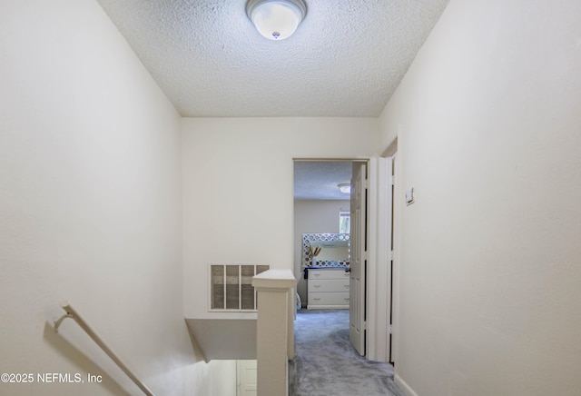 5811 Atlantic Blvd Unit 115, Jacksonville, FL 32207 - hall with an upstairs landing, a textured ceiling, and light carpet