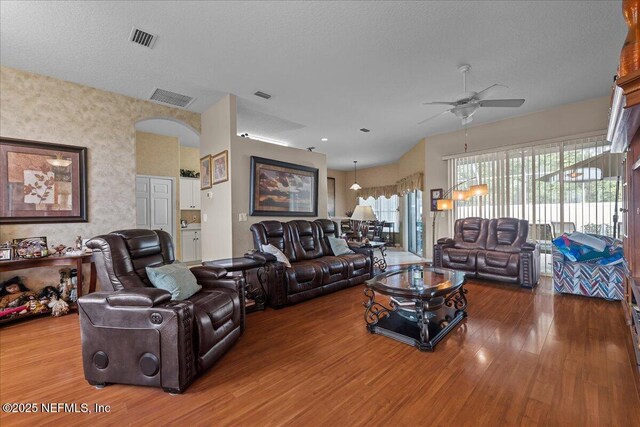 45 E Diamond Dr, Palm Coast, FL 32164 - living area with ceiling fan, wood finished floors, arched walkways, and a textured ceiling