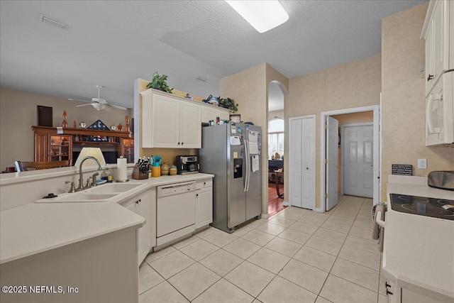 45 E Diamond Dr, Palm Coast, FL 32164 - kitchen with white appliances, a ceiling fan, light tile patterned flooring, white cabinets, and a textured ceiling