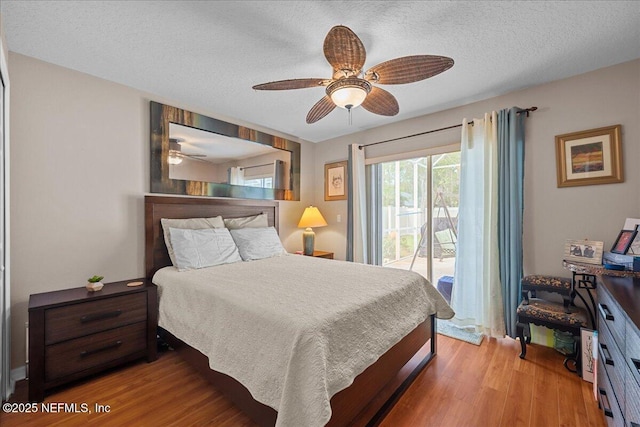 45 E Diamond Dr, Palm Coast, FL 32164 - bedroom with access to exterior, wood finished floors, a textured ceiling, and ceiling fan